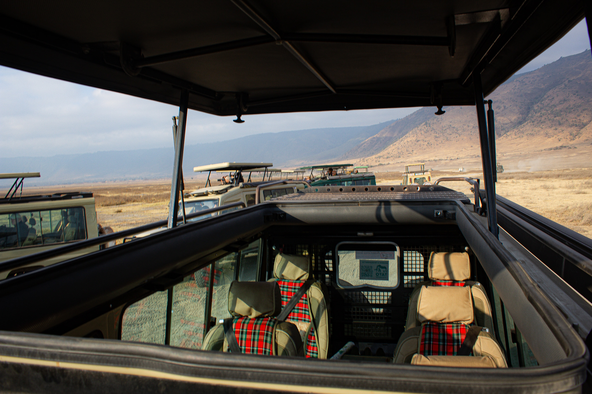 Safari vehicles overlooking the Ngorongoro landscape