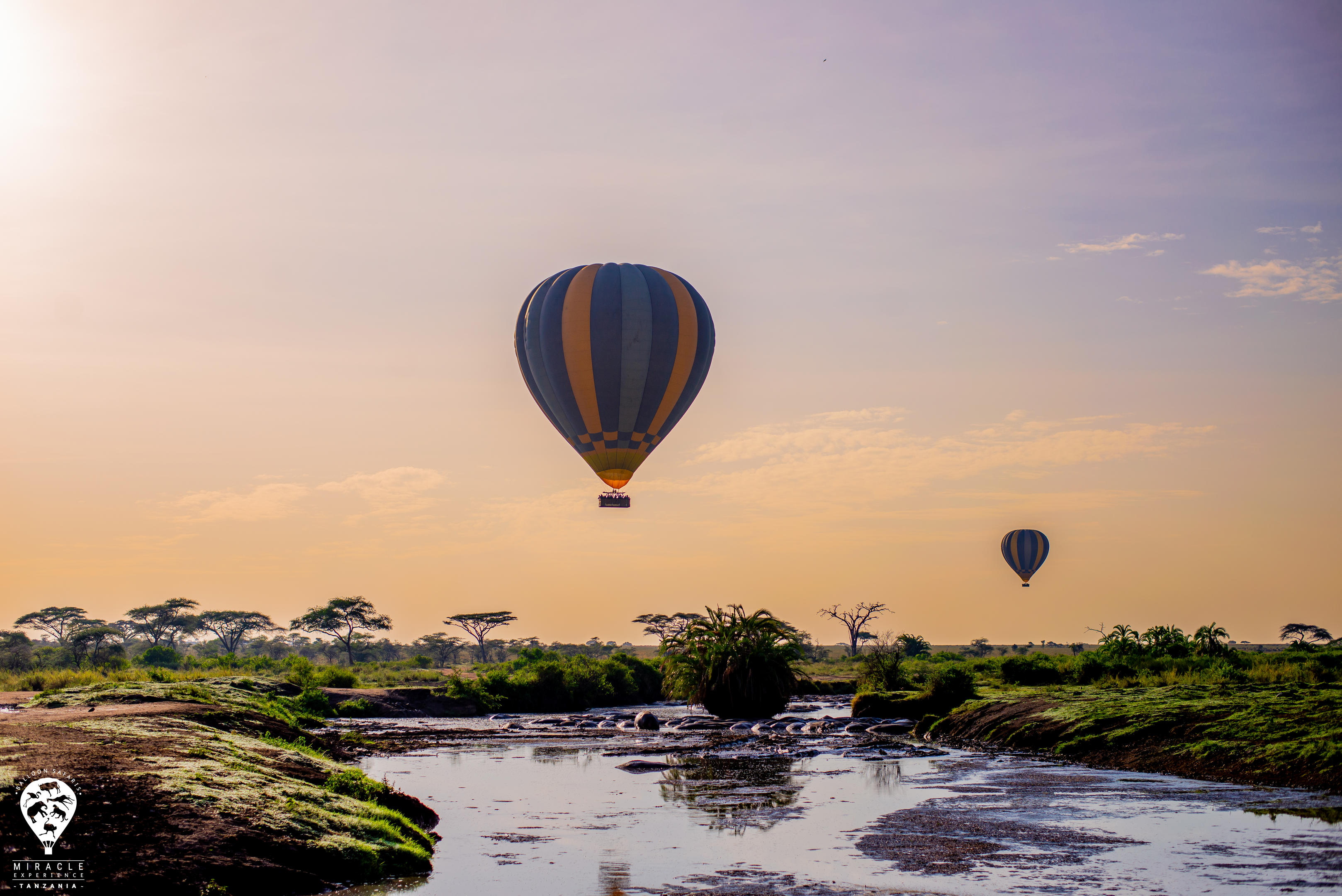 Hot air balloon floating over the Serengeti at sunrise — Tanzania balloon safari by The Luxury Africa DMC