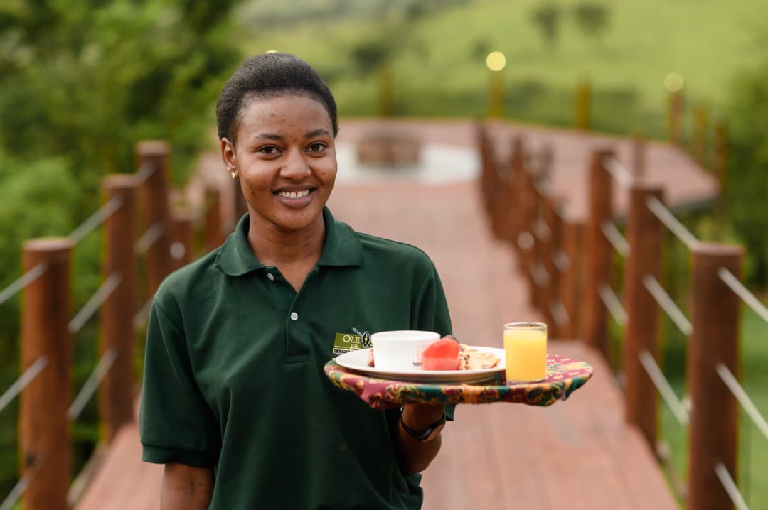 Host welcoming guests with refreshments in Tanzania