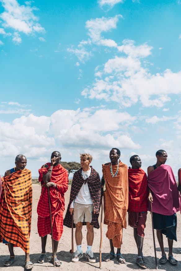 Guest walking with Maasai community members in Tanzania
